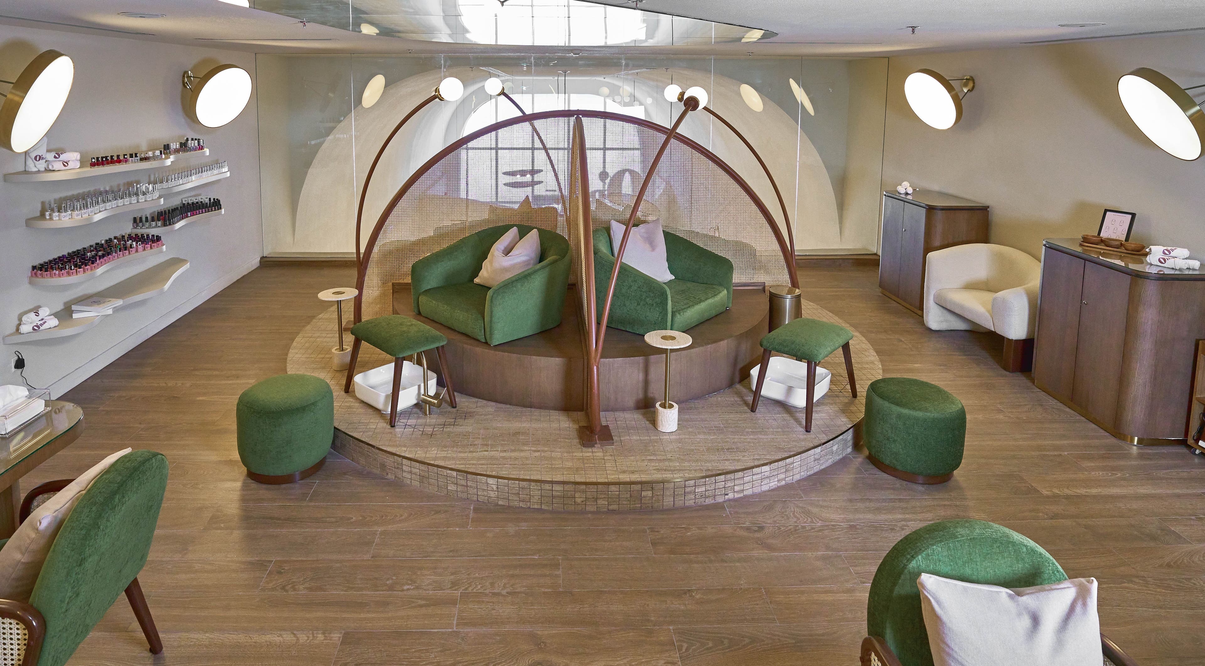 Relaxing pedicure lounge at Obar Beauty, Riyadh, Riyadh Province, SA, featuring elegant green seating and chic decor.