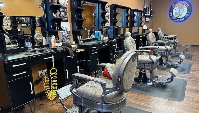 Modern barber chairs and stations at Masters Barbershop in Alpharetta, Georgia, US.