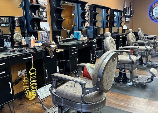 Modern barber chairs and stations at Masters Barbershop in Alpharetta, Georgia, US.