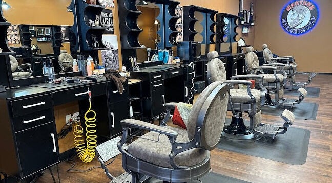 Modern barber chairs and stations at Masters Barbershop in Alpharetta, Georgia, US.