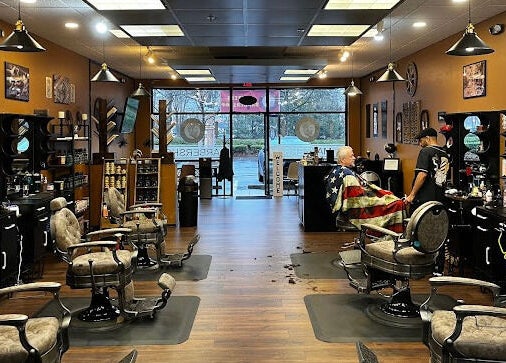Interior of Masters Barbershop in Alpharetta, Georgia, US, showcasing vintage chairs and welcoming atmosphere.