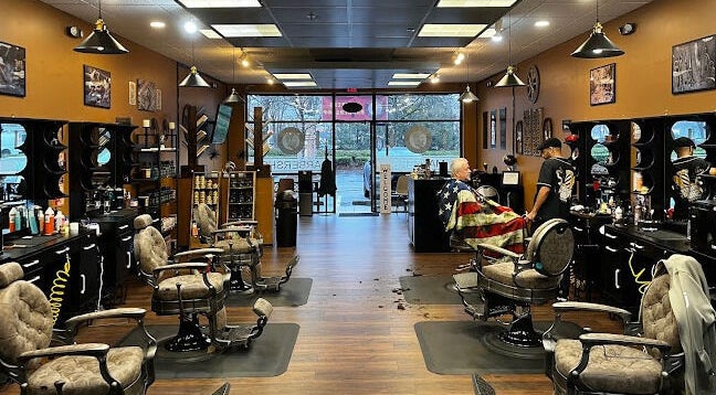 Interior of Masters Barbershop in Alpharetta, Georgia, US, showcasing vintage chairs and welcoming atmosphere.