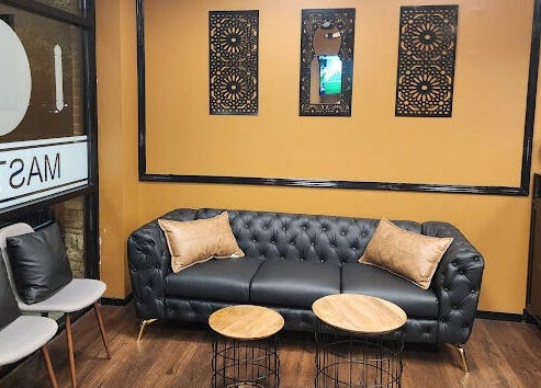 Elegant waiting area at Masters Barbershop in Alpharetta, Georgia, US, with plush seating and decor.