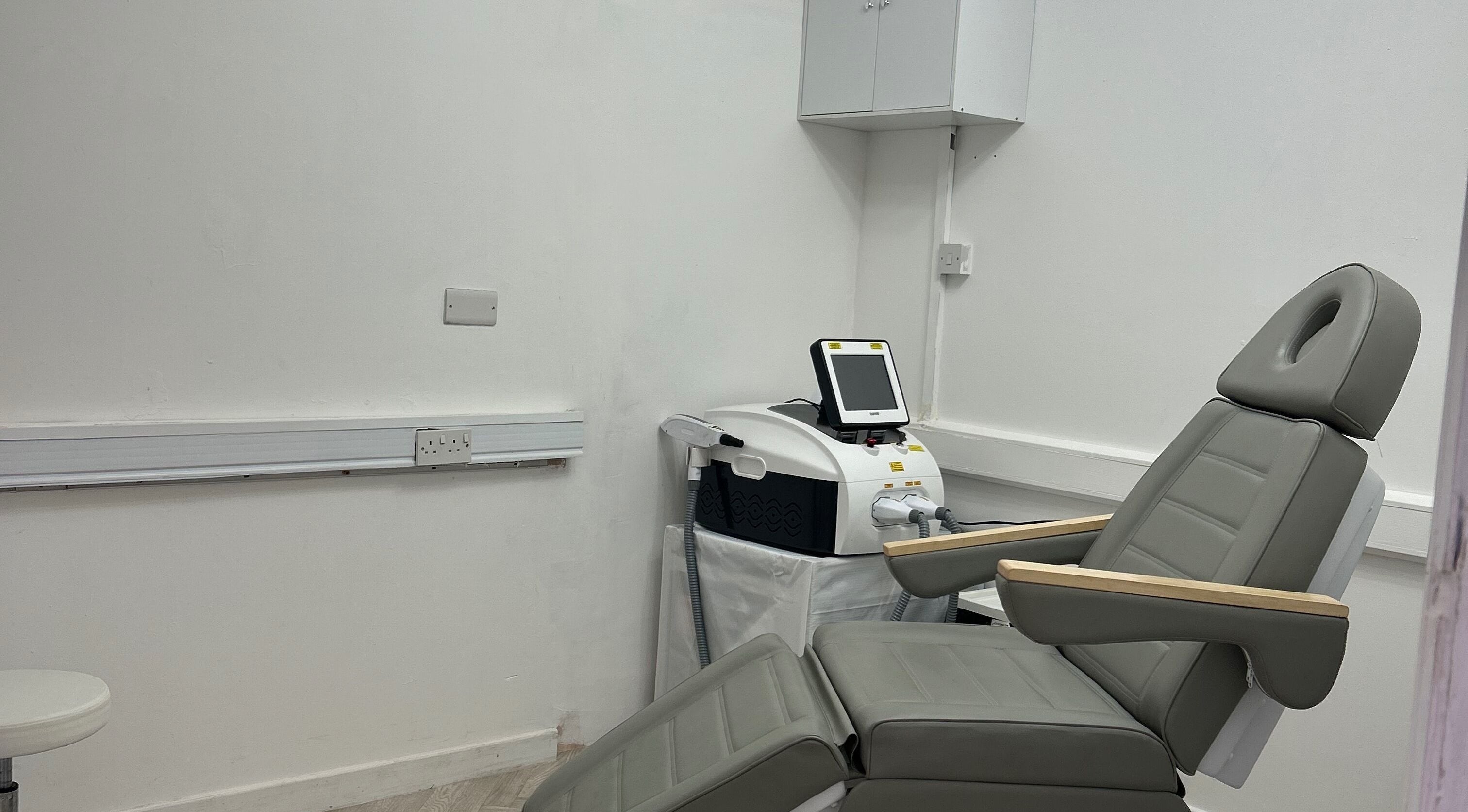 Comfortable treatment room with laser equipment at Laser Luxe Clinic in Rochdale, England, GB.