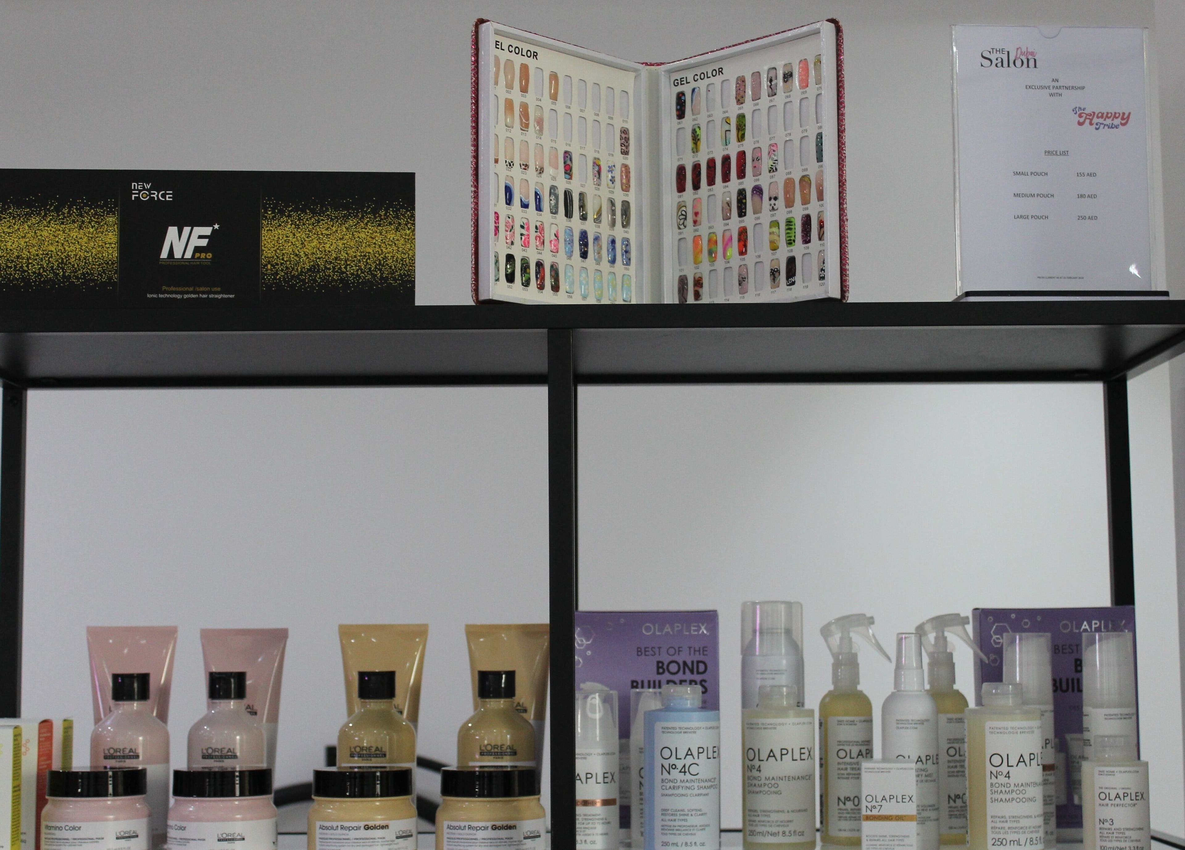 Product display at The Salon at Yin Yang JBR, Dubai, AE showcasing L'Oreal and Olaplex hair care items.