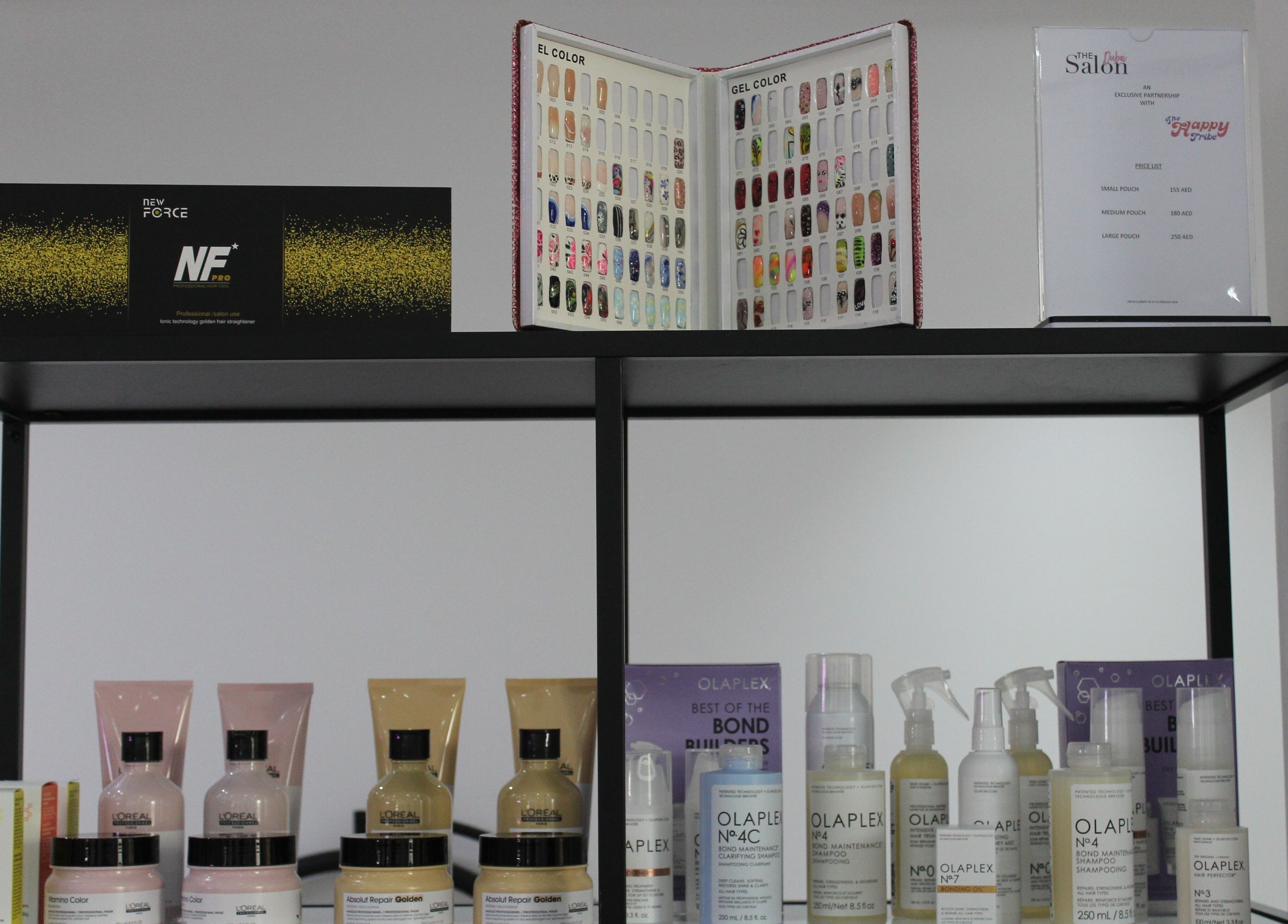 Product display at The Salon at Yin Yang JBR, Dubai, AE showcasing L'Oreal and Olaplex hair care items.