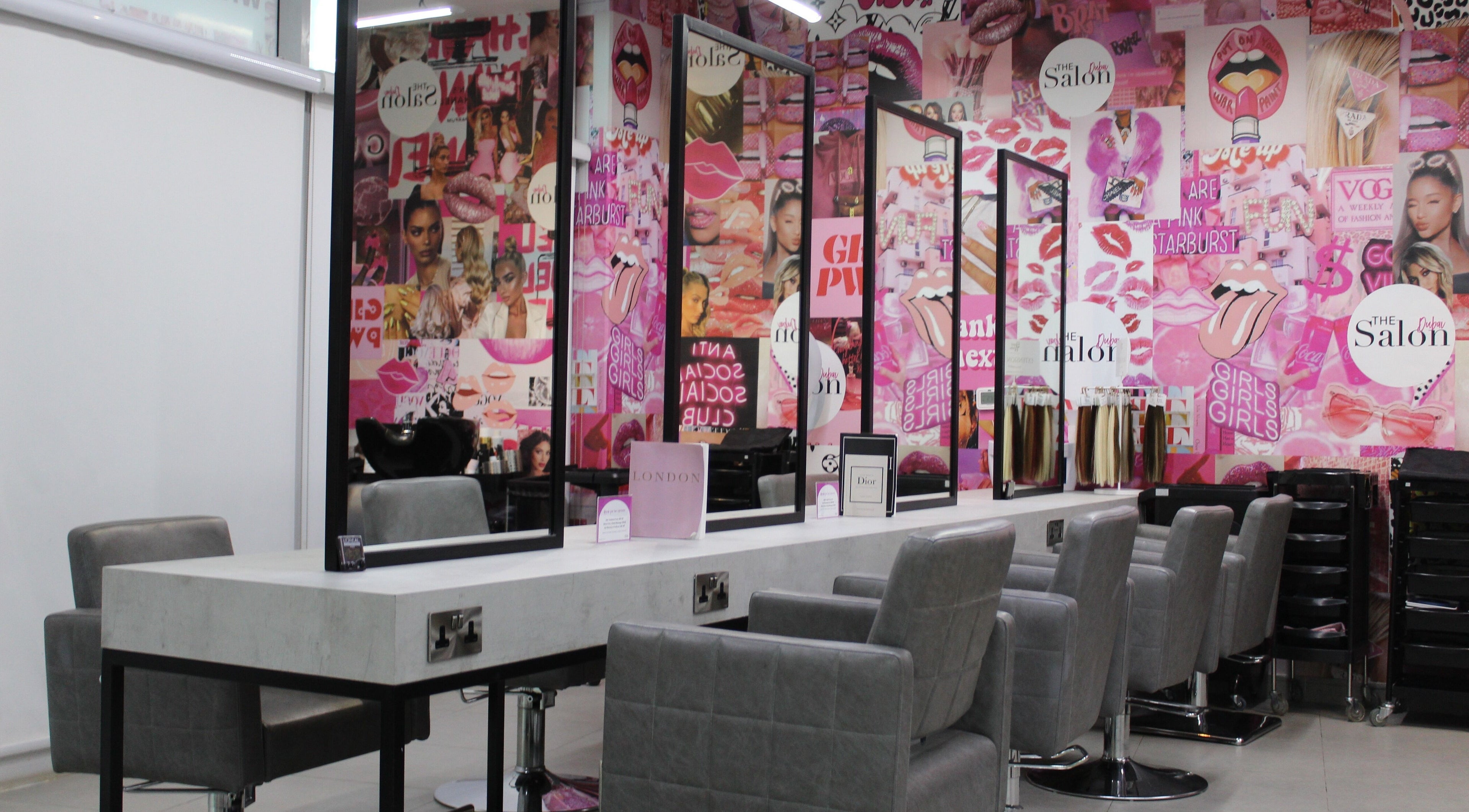 Interior of The Salon at Skyview Tower Marina in Dubai, AE, showcasing stylish mirrors and chairs with vibrant decor.
