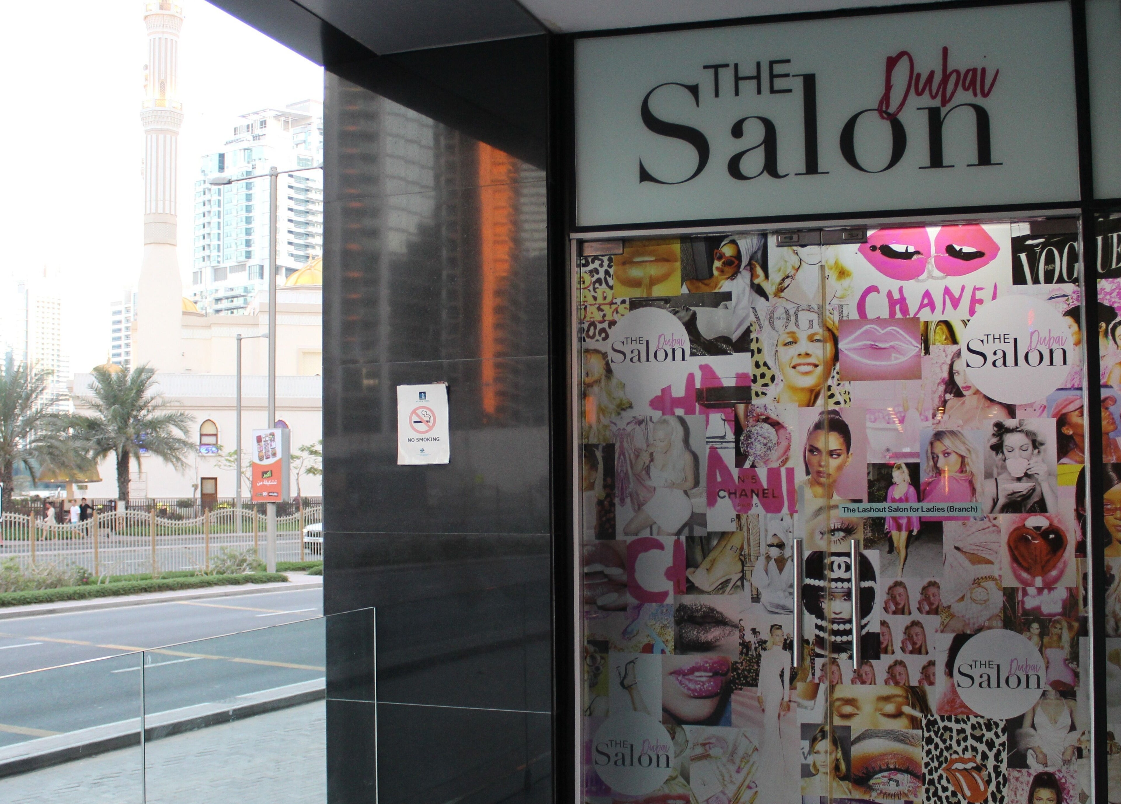 The Salon at Skyview Tower Marina entrance in Dubai, AE, with trendy window decor and nearby street view.