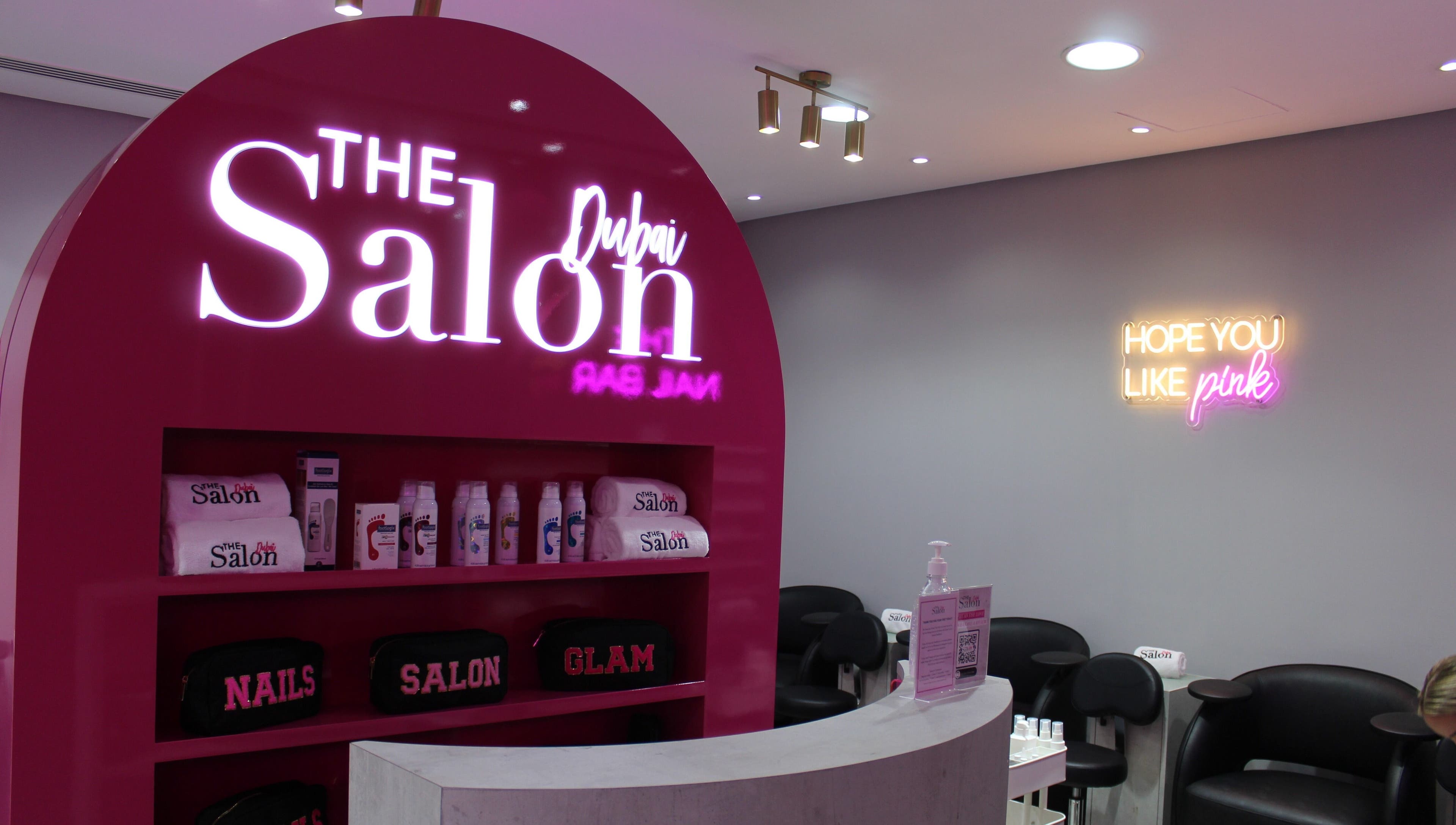 The Salon at Ocean View Hotel JBR in Dubai, AE features bright pink decor with beauty products displayed.