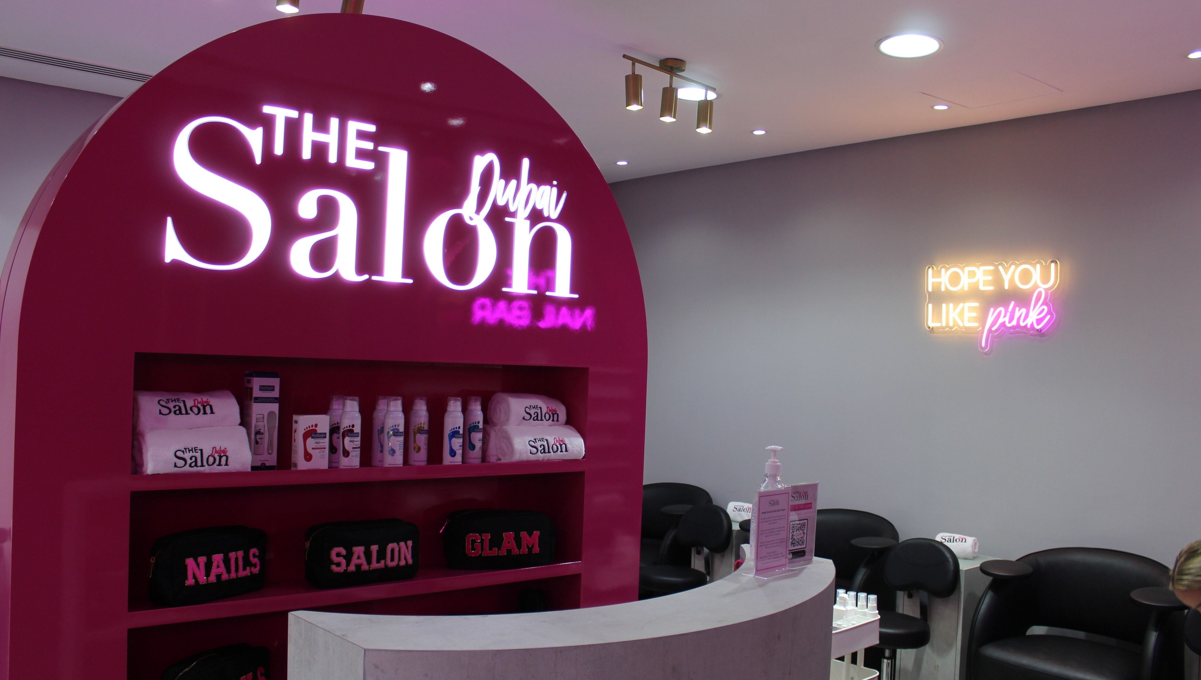 The Salon at Ocean View Hotel JBR in Dubai, AE features bright pink decor with beauty products displayed.