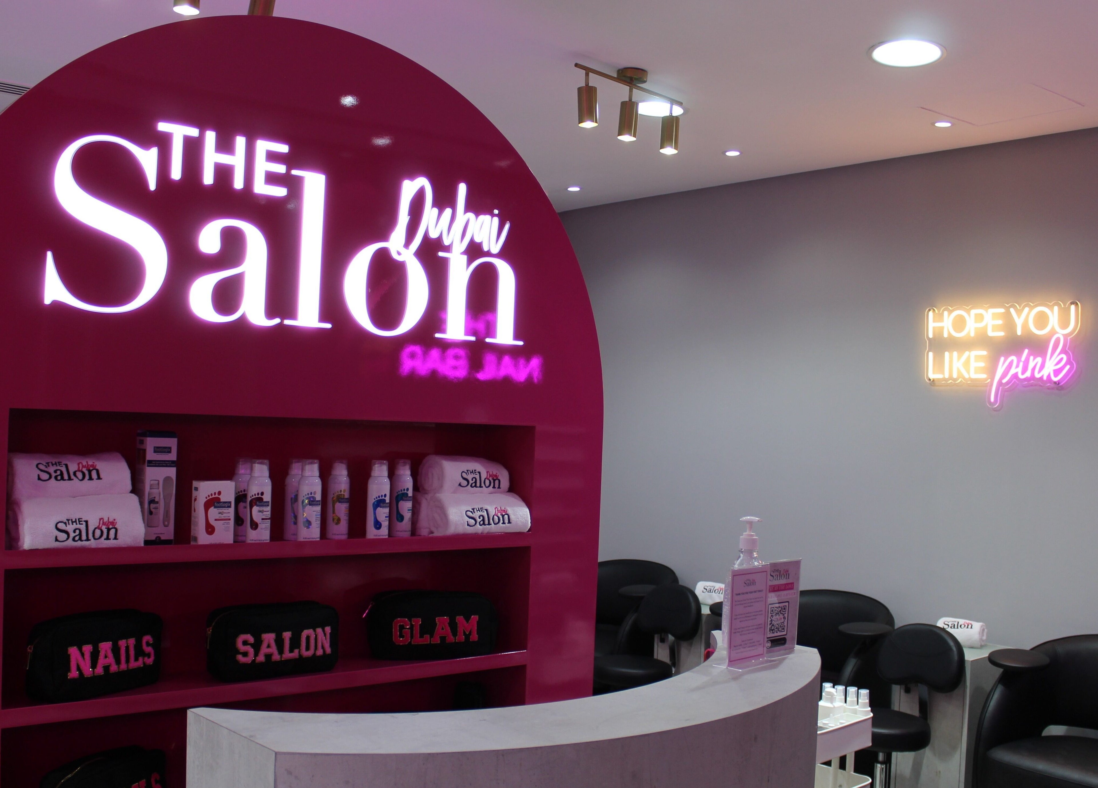 The Salon at Ocean View Hotel JBR in Dubai, AE features bright pink decor with beauty products displayed.