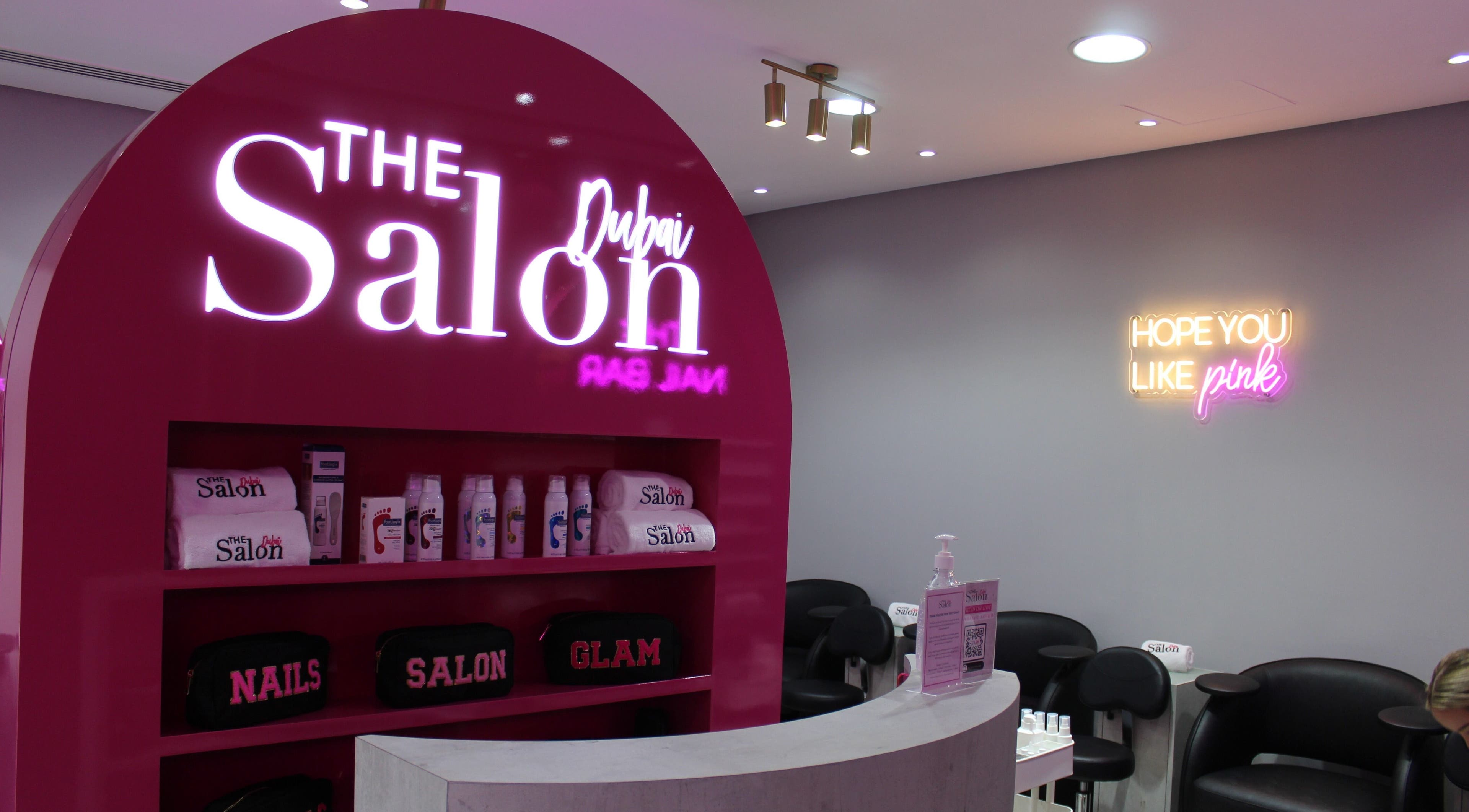 The Salon at Ocean View Hotel JBR in Dubai, AE features bright pink decor with beauty products displayed.
