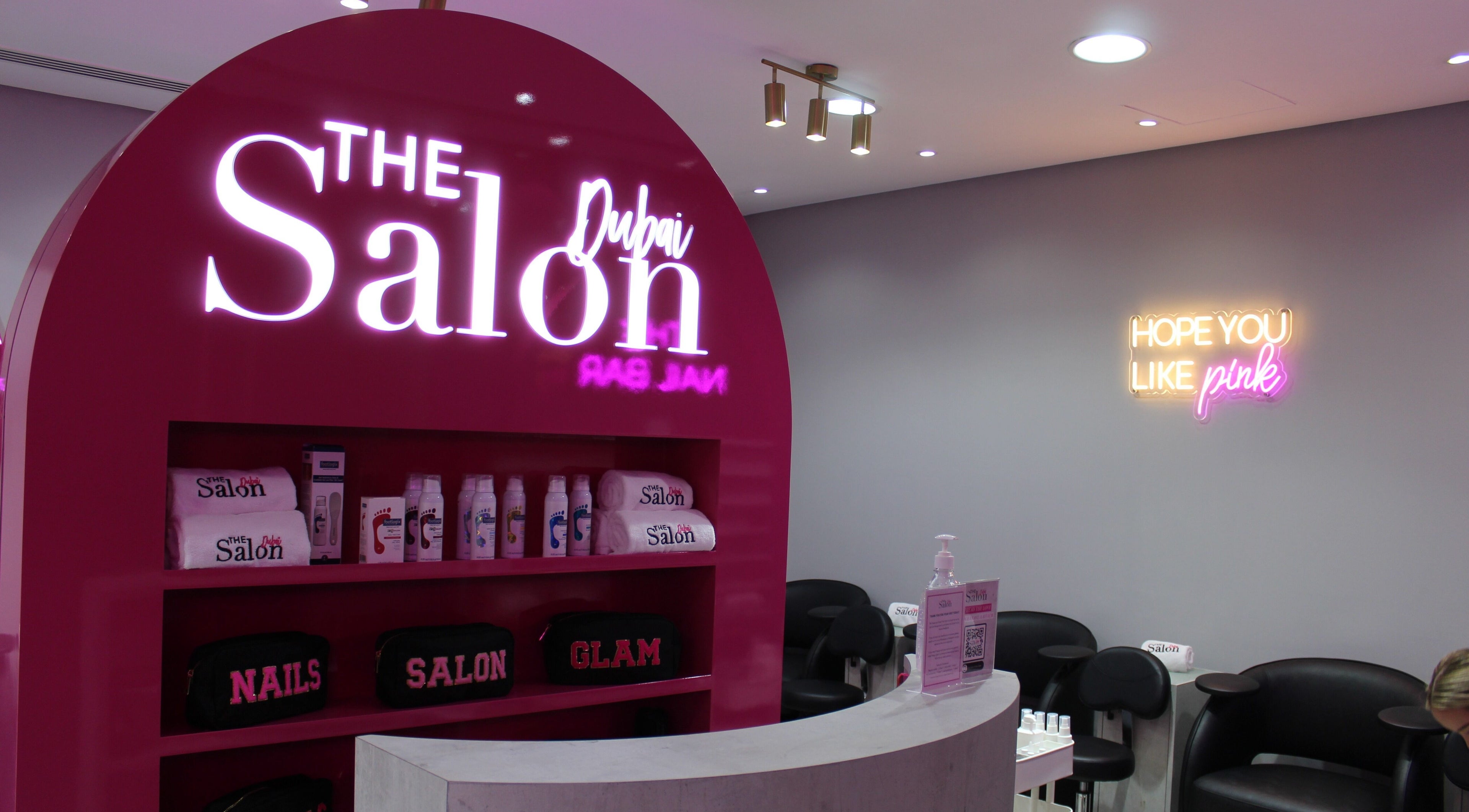 The Salon at Ocean View Hotel JBR in Dubai, AE features bright pink decor with beauty products displayed.