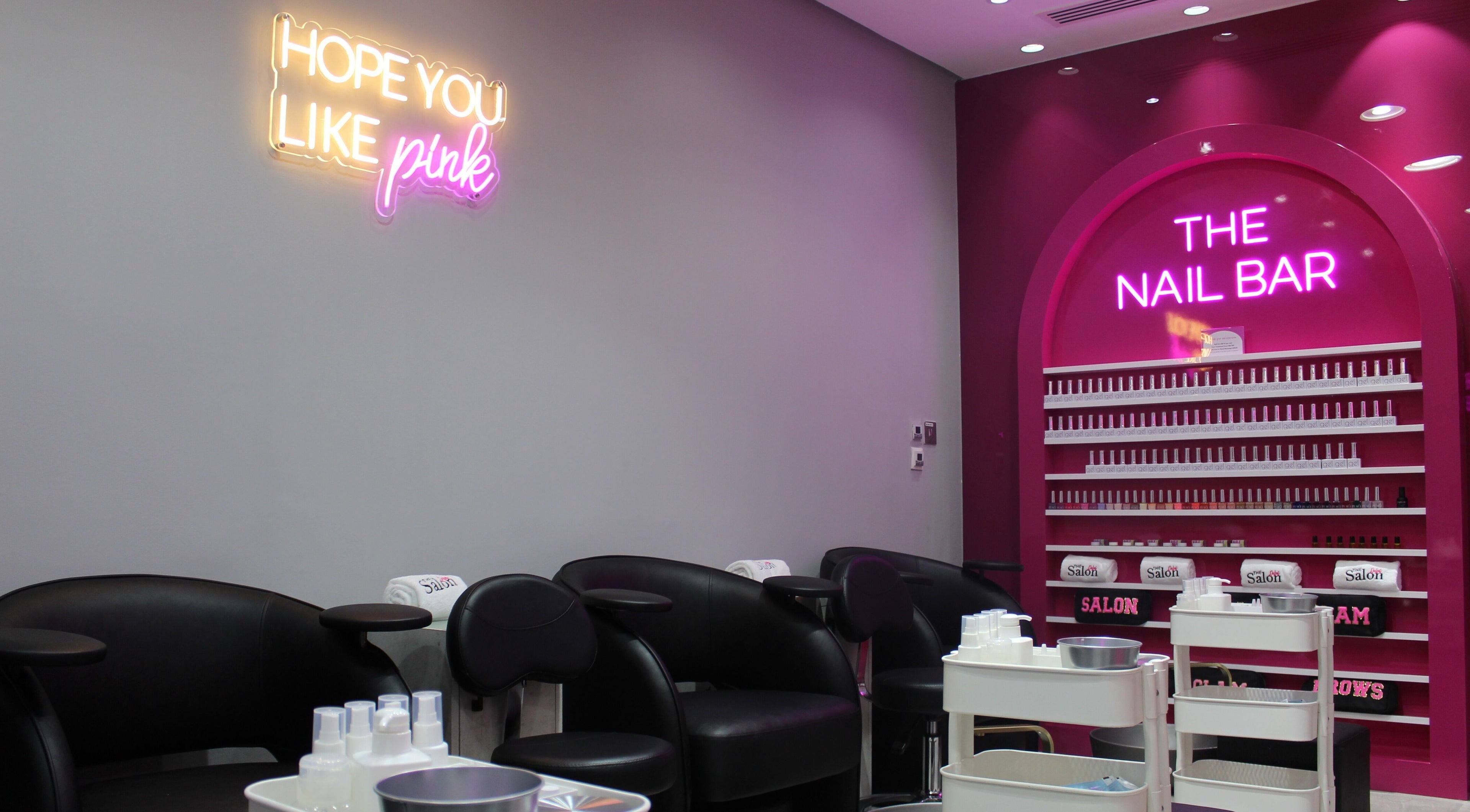 The Salon at Ocean View Hotel JBR, Dubai, AE features chic pink nail bar with neon lights and modern seating.