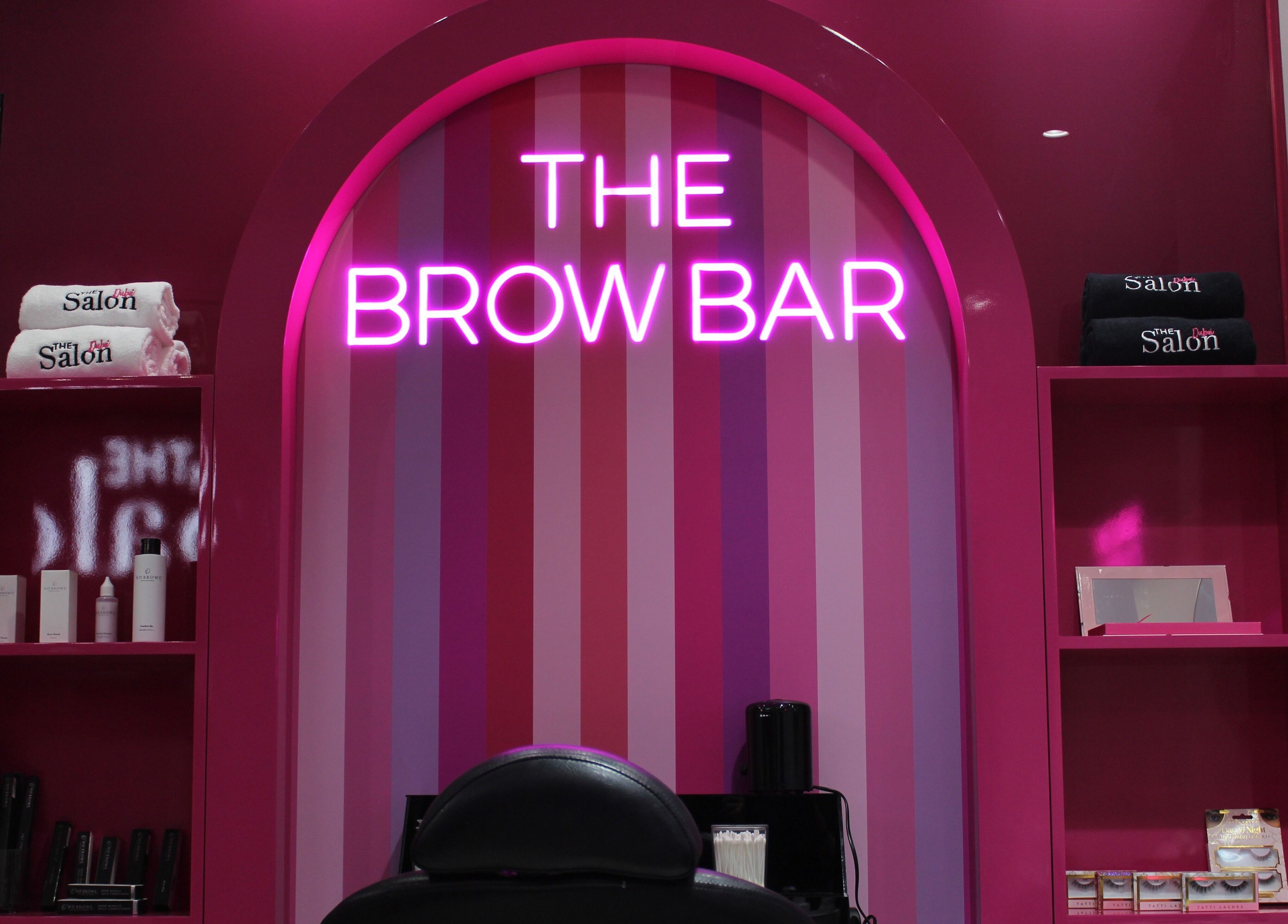 Vibrant Brow Bar at The Salon at Ocean View Hotel JBR, Dubai, AE with glowing pink neon sign and products.