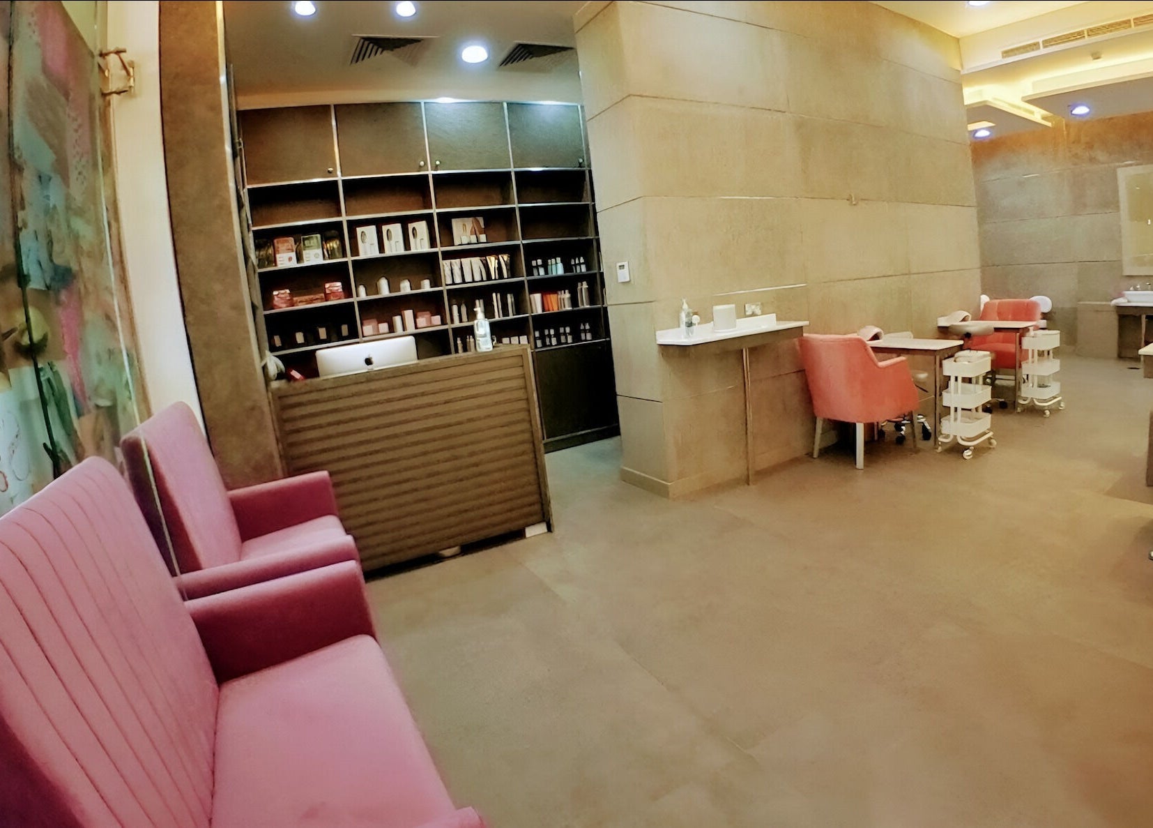 Interior of The Salon at Yin Yang Al Wasl, Dubai, AE with pink seating and shelves.