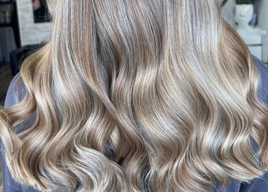 Blonde waves styled at Poppy Harrison Hair, Blackpool, England, GB, showcasing glossy finish.
