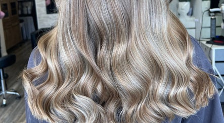 Blonde waves styled at Poppy Harrison Hair, Blackpool, England, GB, showcasing glossy finish.