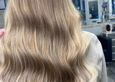 Blonde wavy hair styled at Poppy Harrison Hair, Blackpool, England, GB, showcasing smooth, healthy locks.