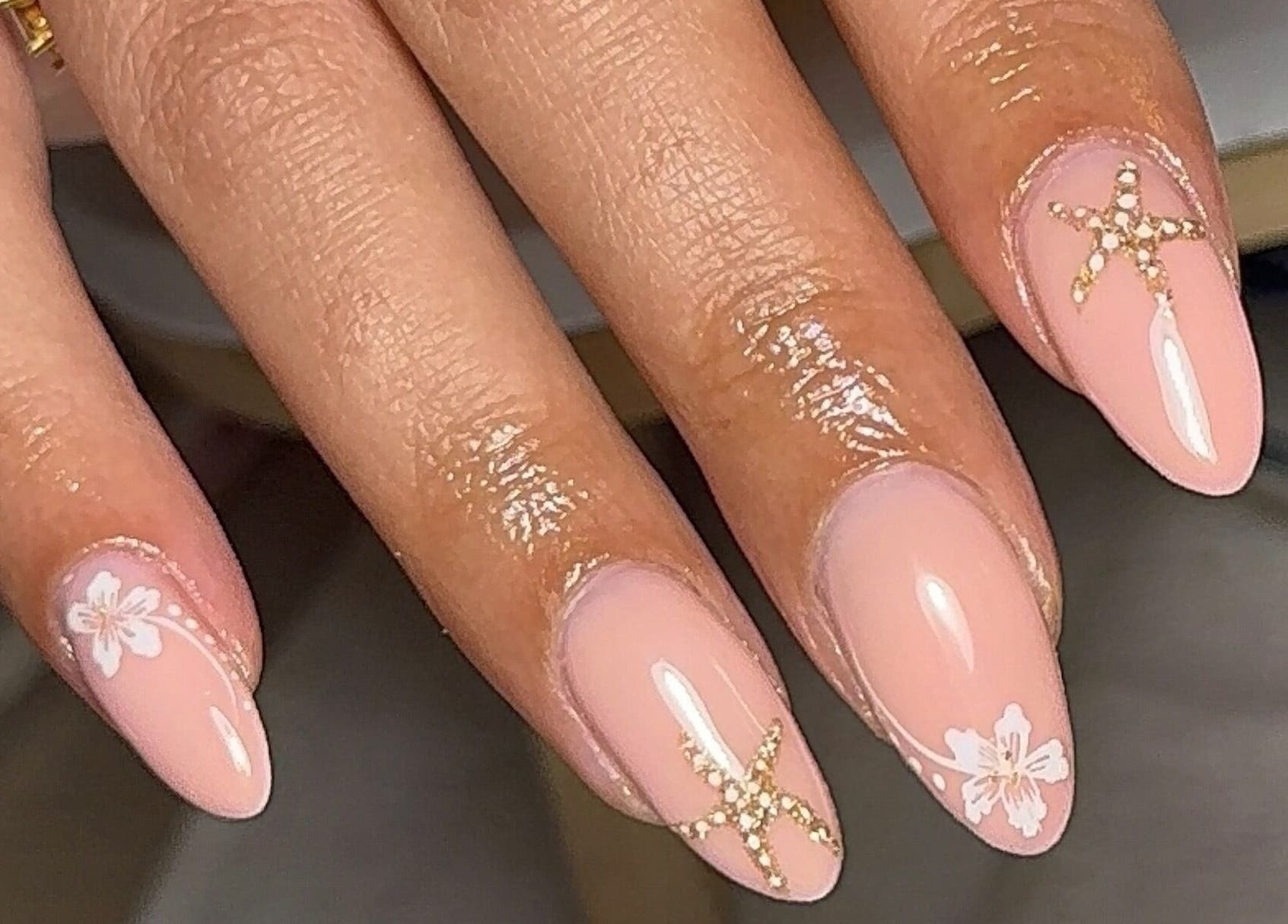 Chic nail design with floral accents at BY.M.R.B, Colchester, England, GB. Perfect for elegant occasions.