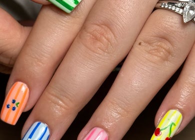 Colorful nail art showcasing fruity designs at BY.M.R.B, Colchester, England, GB.