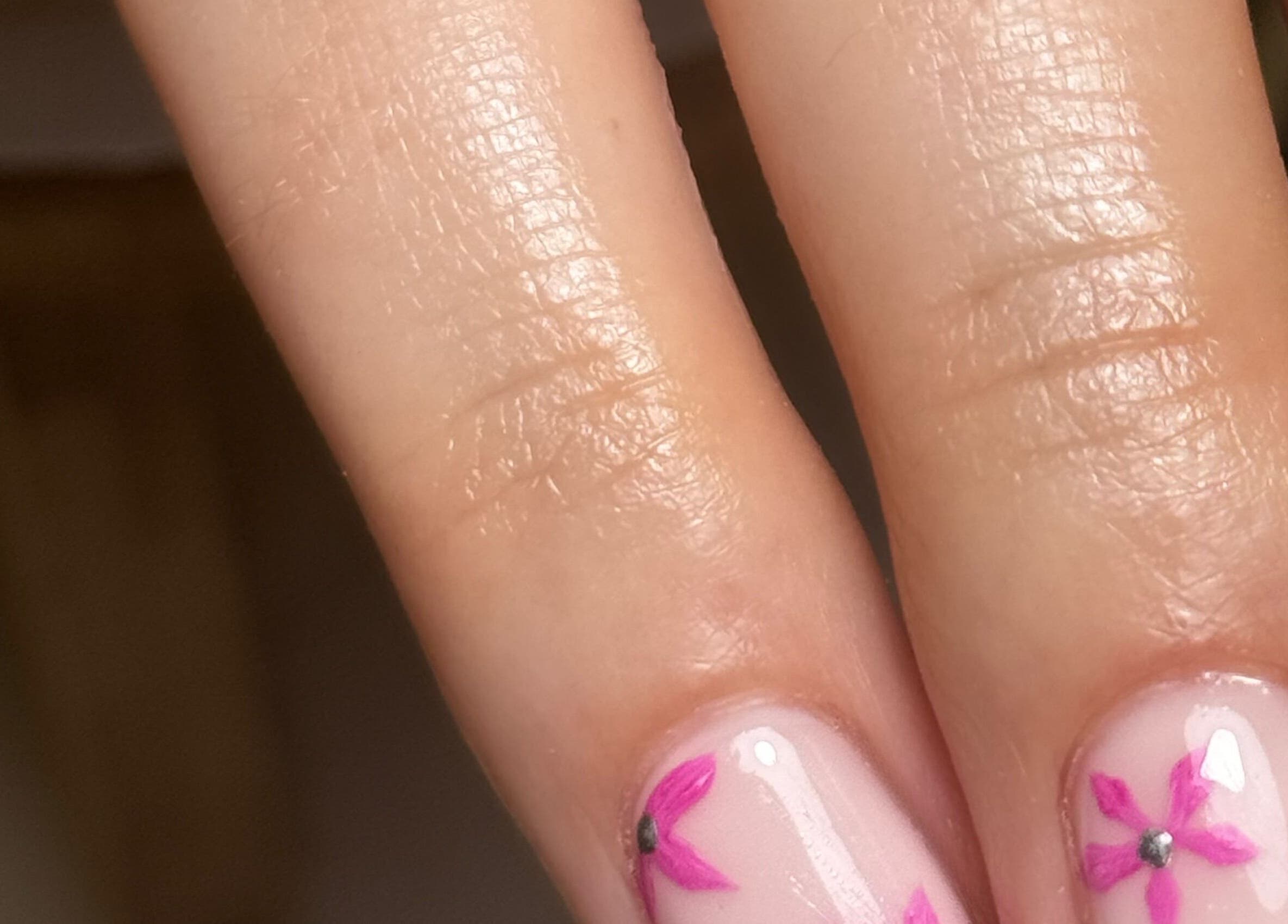 Close-up of pink floral nail art at BY.M.R.B, Colchester, England, GB.