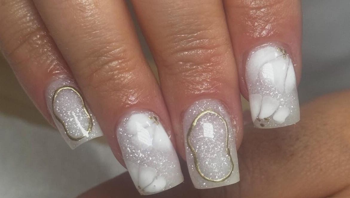 Sparkling white and gold nail design at By Tara-Jayne, Bridgwater, England, GB.