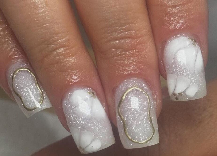 Sparkling white and gold nail design at By Tara-Jayne, Bridgwater, England, GB.