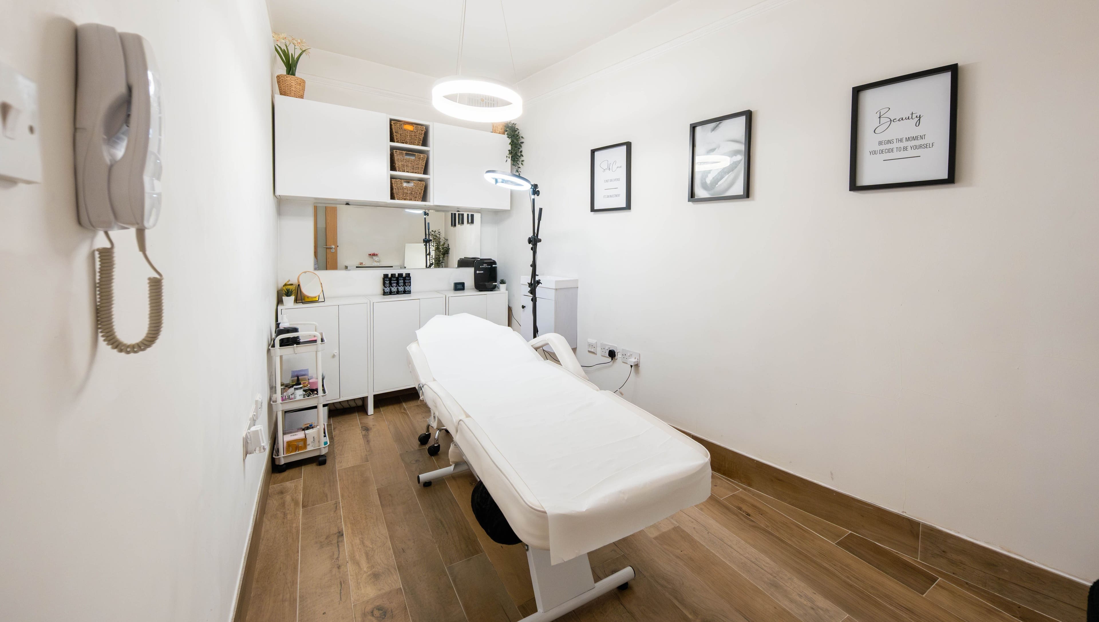 Modern treatment room at Jeta Brows in London, England, GB, featuring a comfortable treatment bed and chic decor.