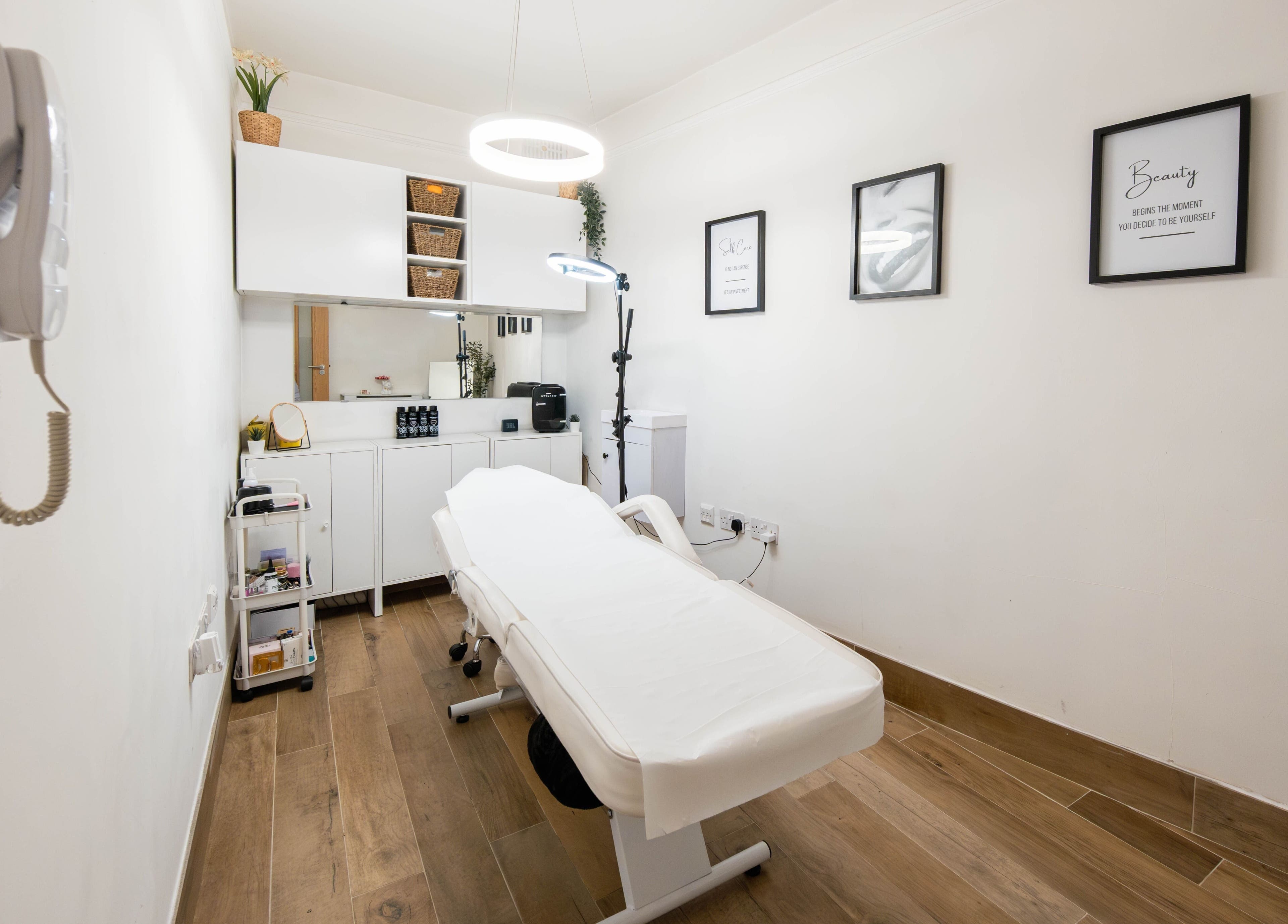 Modern treatment room at Jeta Brows in London, England, GB, featuring a comfortable treatment bed and chic decor.