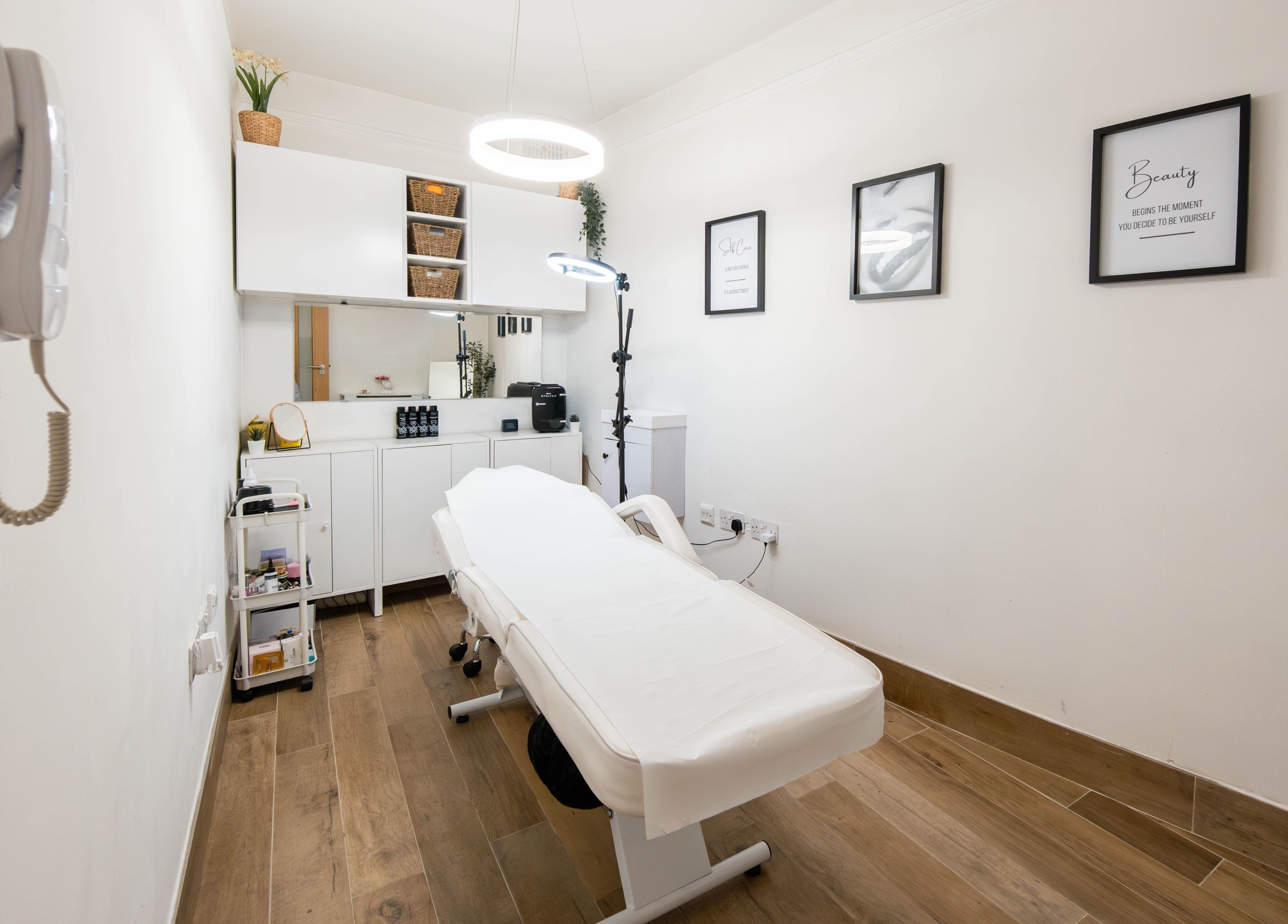 Modern treatment room at Jeta Brows in London, England, GB, featuring a comfortable treatment bed and chic decor.