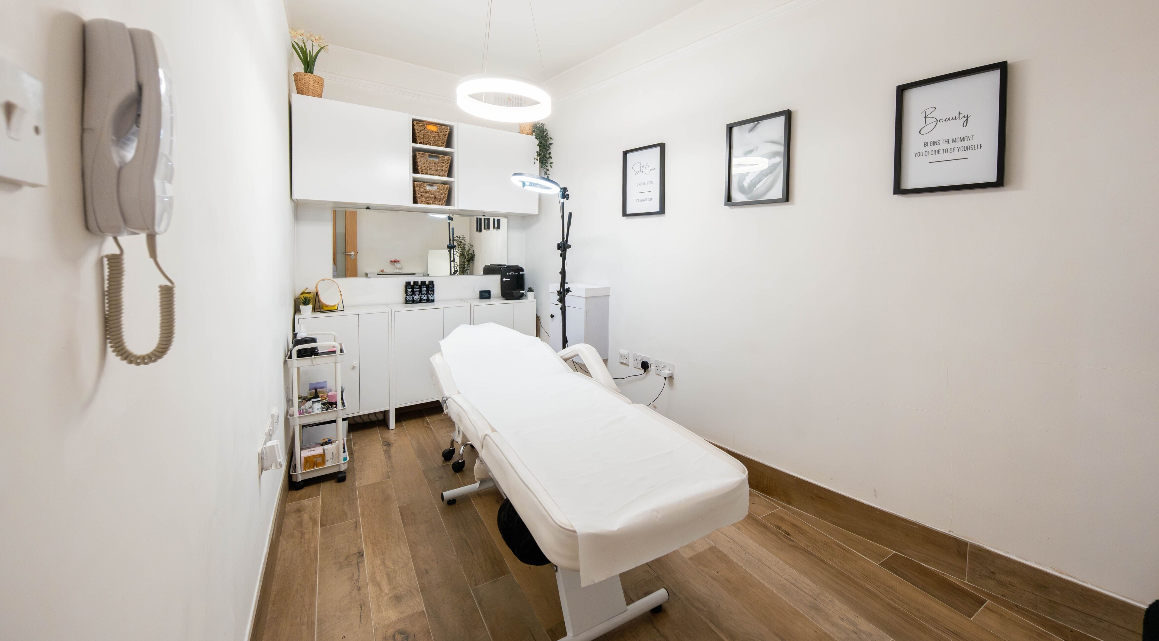 Modern treatment room at Jeta Brows in London, England, GB, featuring a comfortable treatment bed and chic decor.
