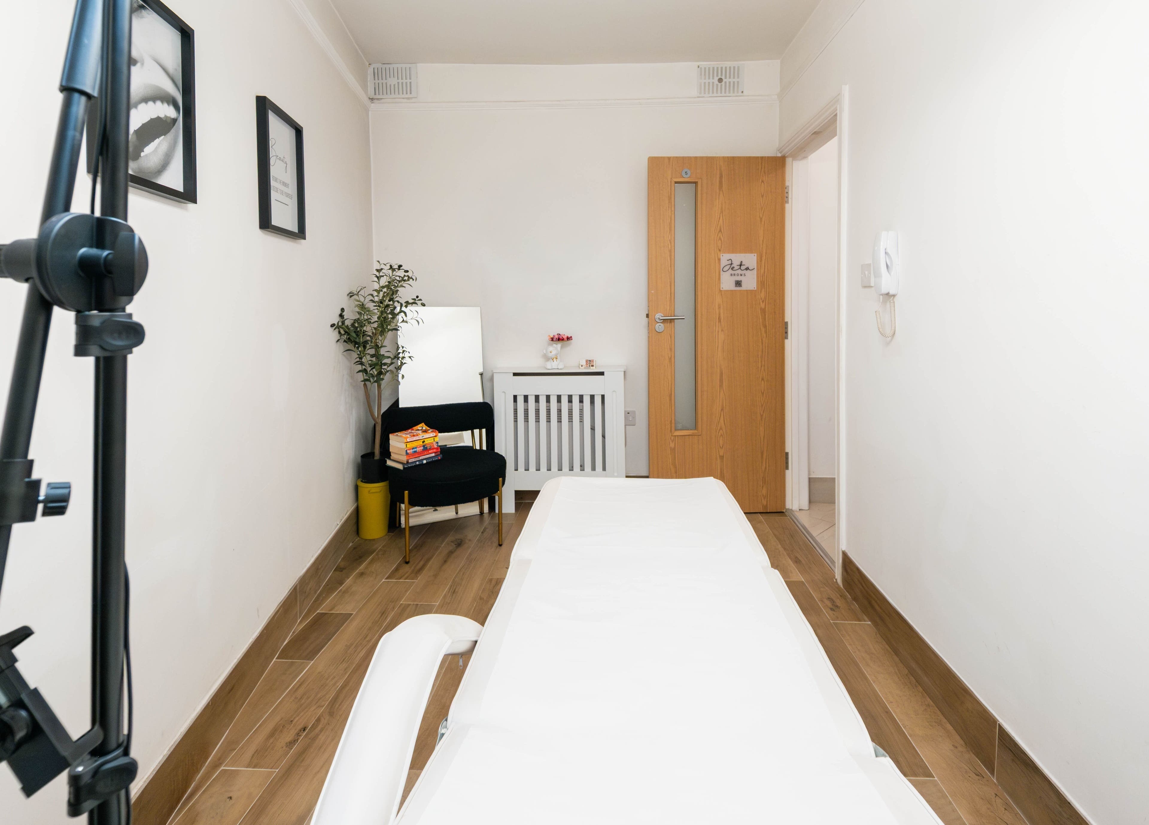 Cozy treatment room at Jeta Brows, London, England, GB, highlighting comfort and relaxation.