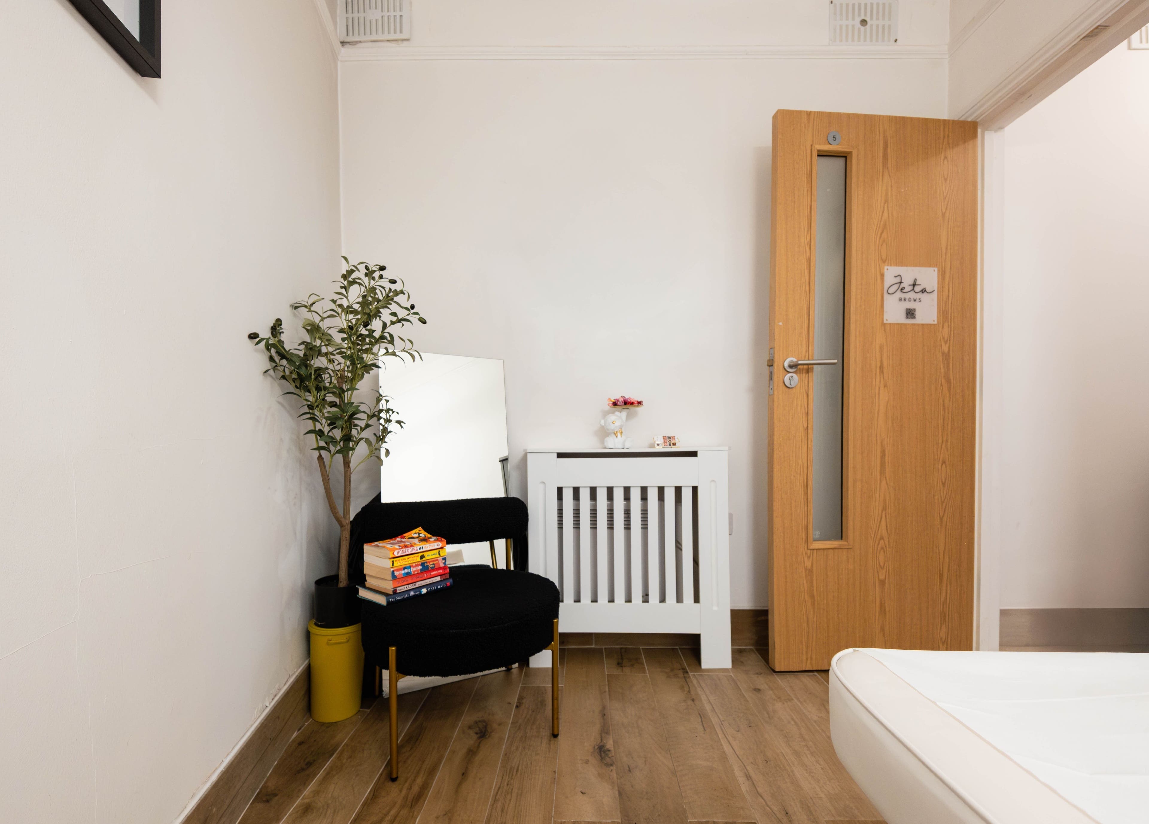 Inviting relaxation space at Jeta Brows, London, England, GB with chair and decor.