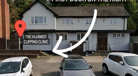 Front view of The Hijamist, a cupping clinic in Stourbridge, England, GB with parked cars in front.
