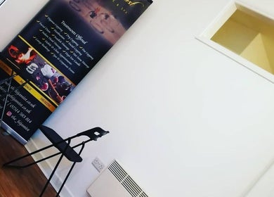 Interior view of The Hijamist in Stourbridge, England, GB featuring elegant chairs and a promotional banner.