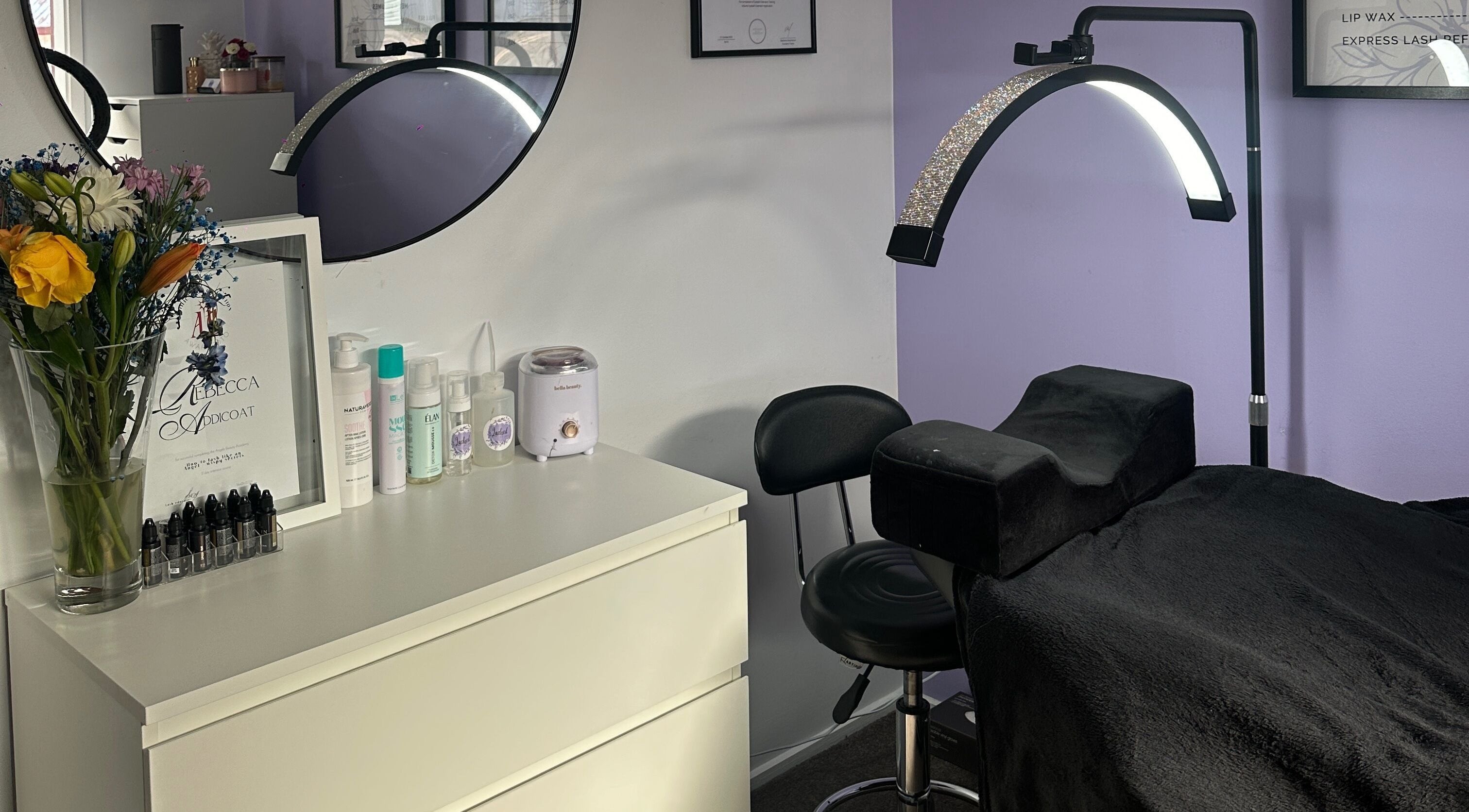 Lashed by Bec's serene studio interior in Melbourne, Victoria, AU with plush treatment bed and floral decor.