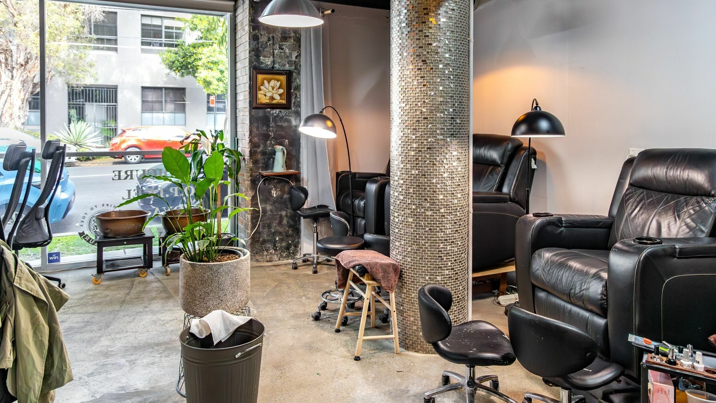 La Coeur Alexandria's modern relaxation area in Alexandria, New South Wales, AU with lush plants and cozy chairs.