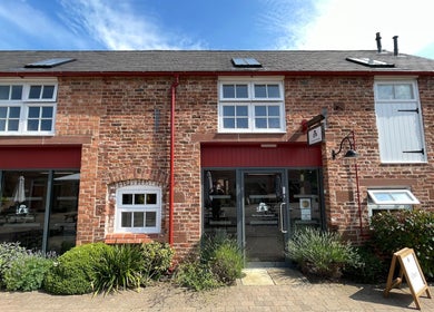 Charming brick facade of The Scissor Psychologist in Aldford, Chester, England, GB, offering beauty services.