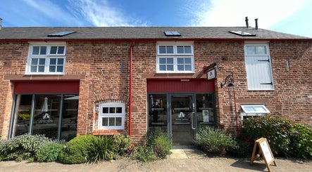 Charming brick facade of The Scissor Psychologist in Aldford, Chester, England, GB, offering beauty services.
