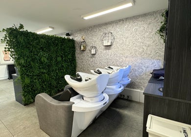 Modern wash stations at The Scissor Psychologist in Aldford, Chester, England, GB with green wall accents.