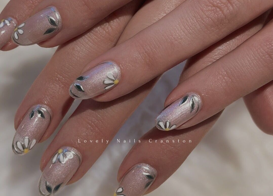 Delicate daisy nail art at Lovely Nails Spa, Cranston, Rhode Island, US, showcasing intricate floral design.