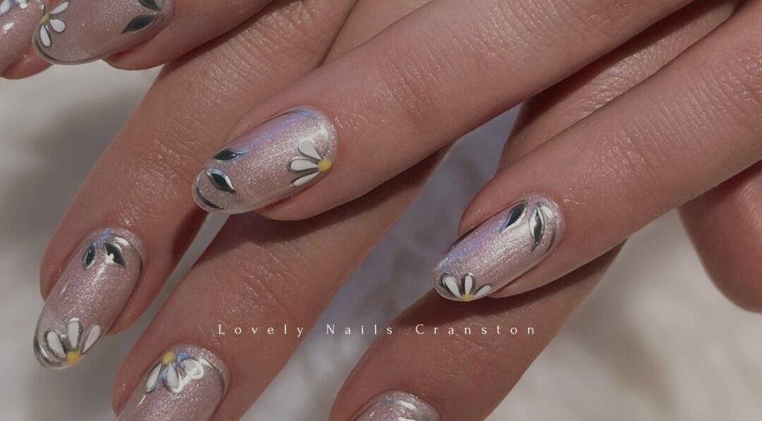 Delicate daisy nail art at Lovely Nails Spa, Cranston, Rhode Island, US, showcasing intricate floral design.