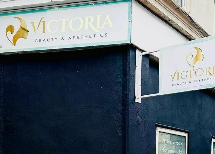 Exterior signage of Victoria Beauty and Aesthetics in London, England, GB on a stylish dark building corner.