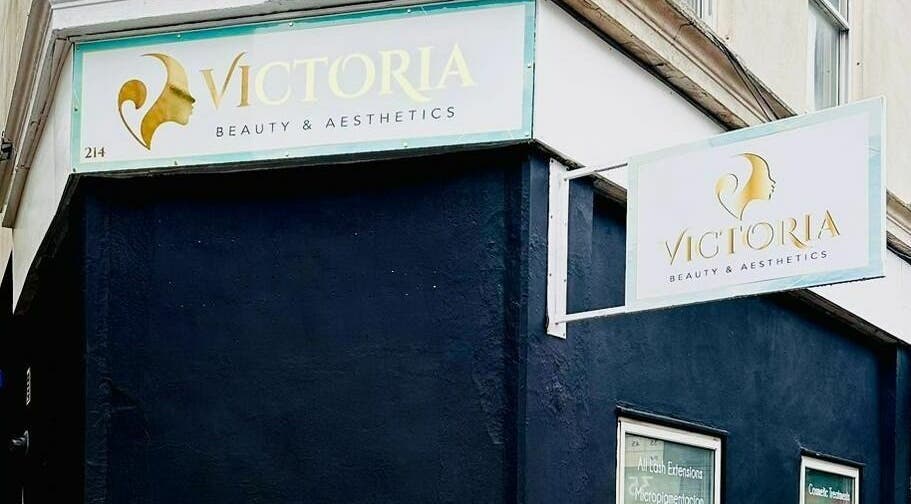 Exterior signage of Victoria Beauty and Aesthetics in London, England, GB on a stylish dark building corner.