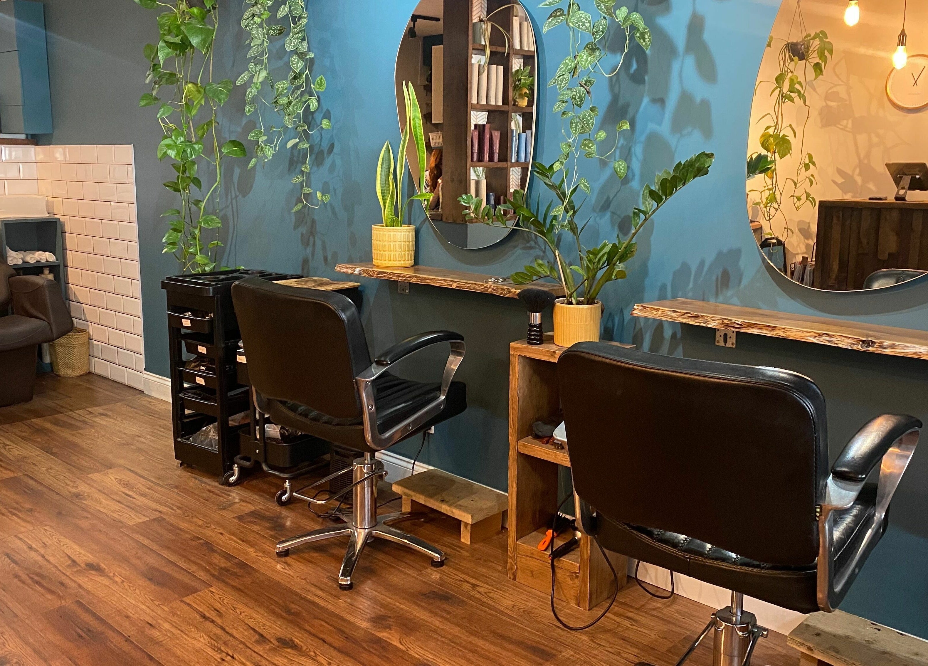 Stylish salon interior at Lazarus Hair, Brighton, England, GB with modern decor and elegant chairs.