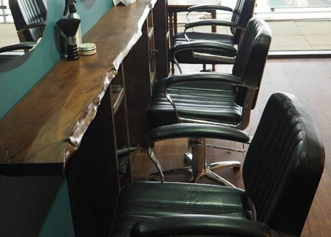 Chic salon chairs at Lazarus Hair, Brighton, England, GB showcasing a stylish and modern interior.
