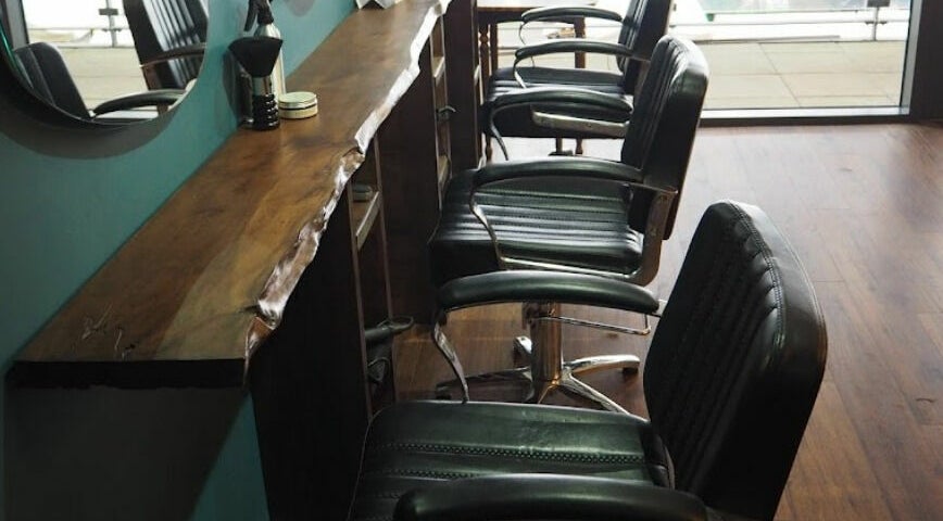 Chic salon chairs at Lazarus Hair, Brighton, England, GB showcasing a stylish and modern interior.