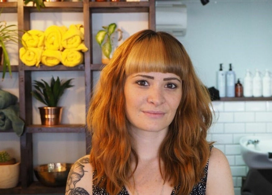 Warm, cozy interior of Lazarus Hair in Brighton, England, GB, featuring a stylist and elegant decor.