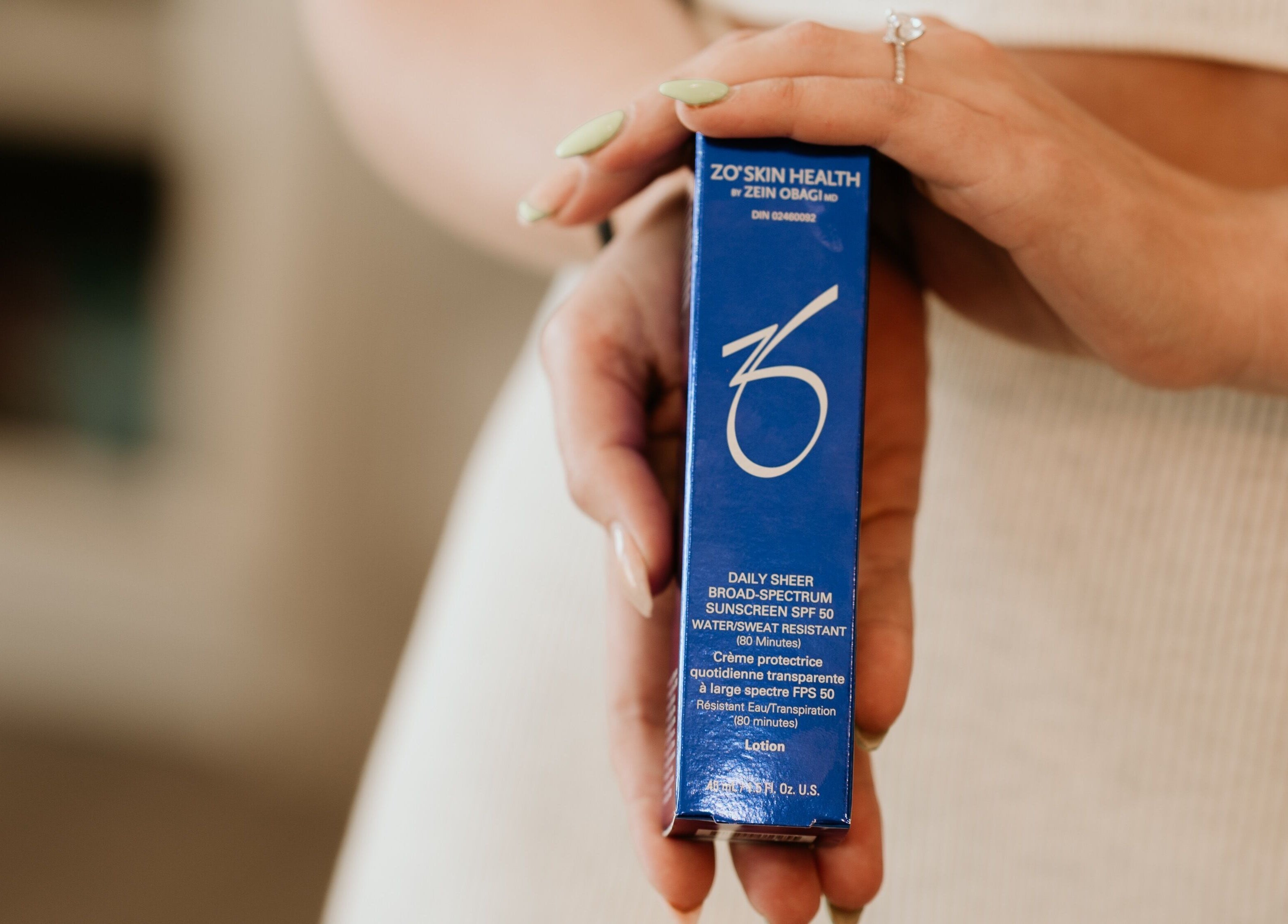 Skin Deep Medical Aesthetics in Carlyle, SK, CA showcases premium skincare sunscreen in blue packaging.